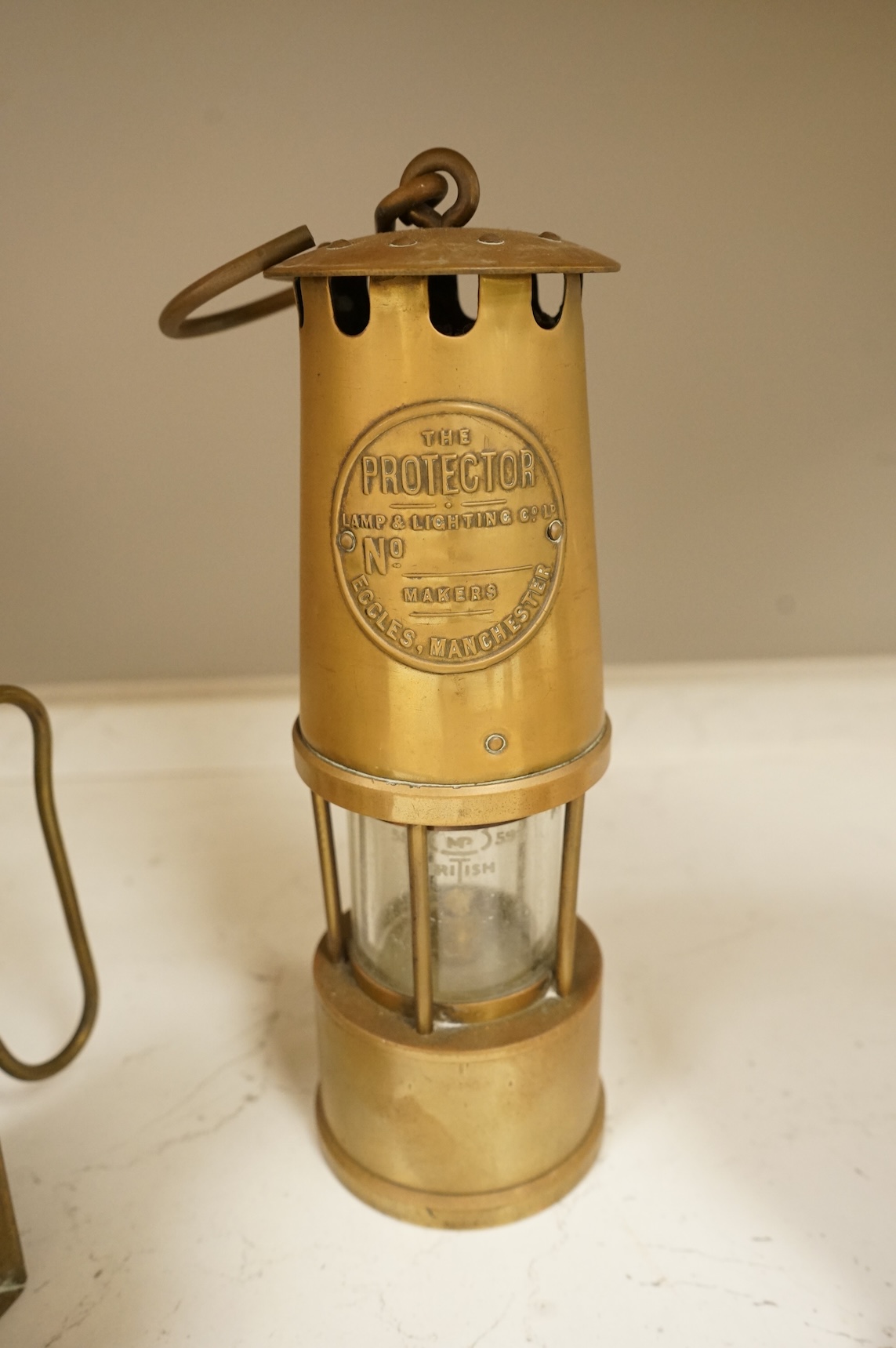 A railway lamp, a vintage Eccles Protector miners lamp and another, largest 17cm high
